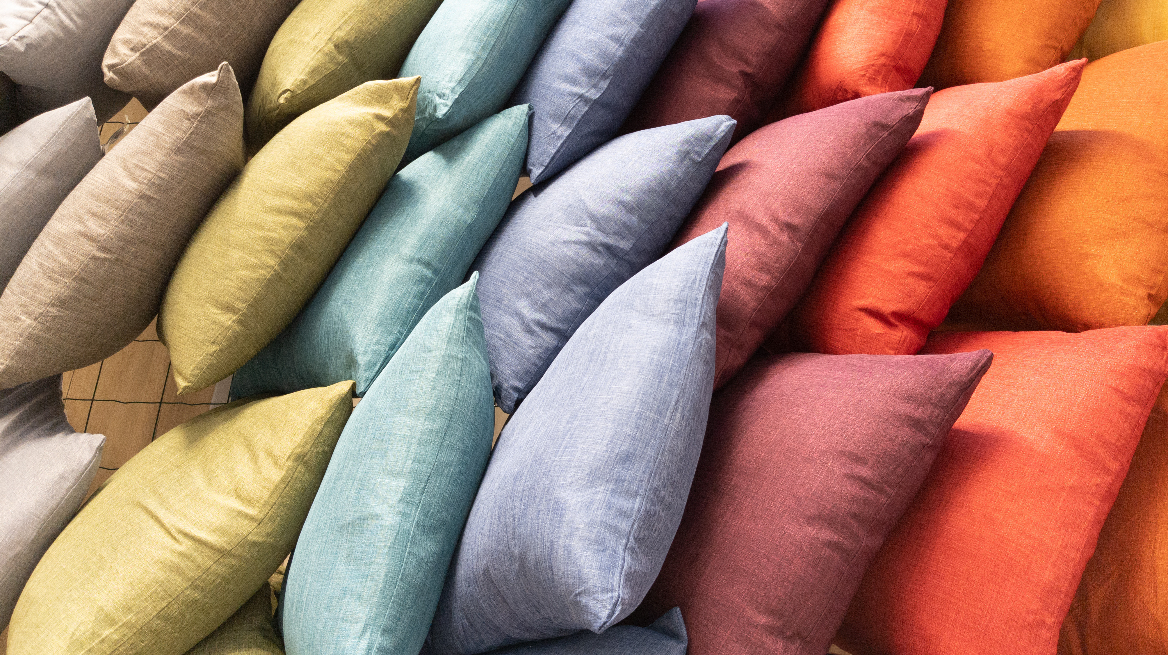 Different colored pillows stacked up