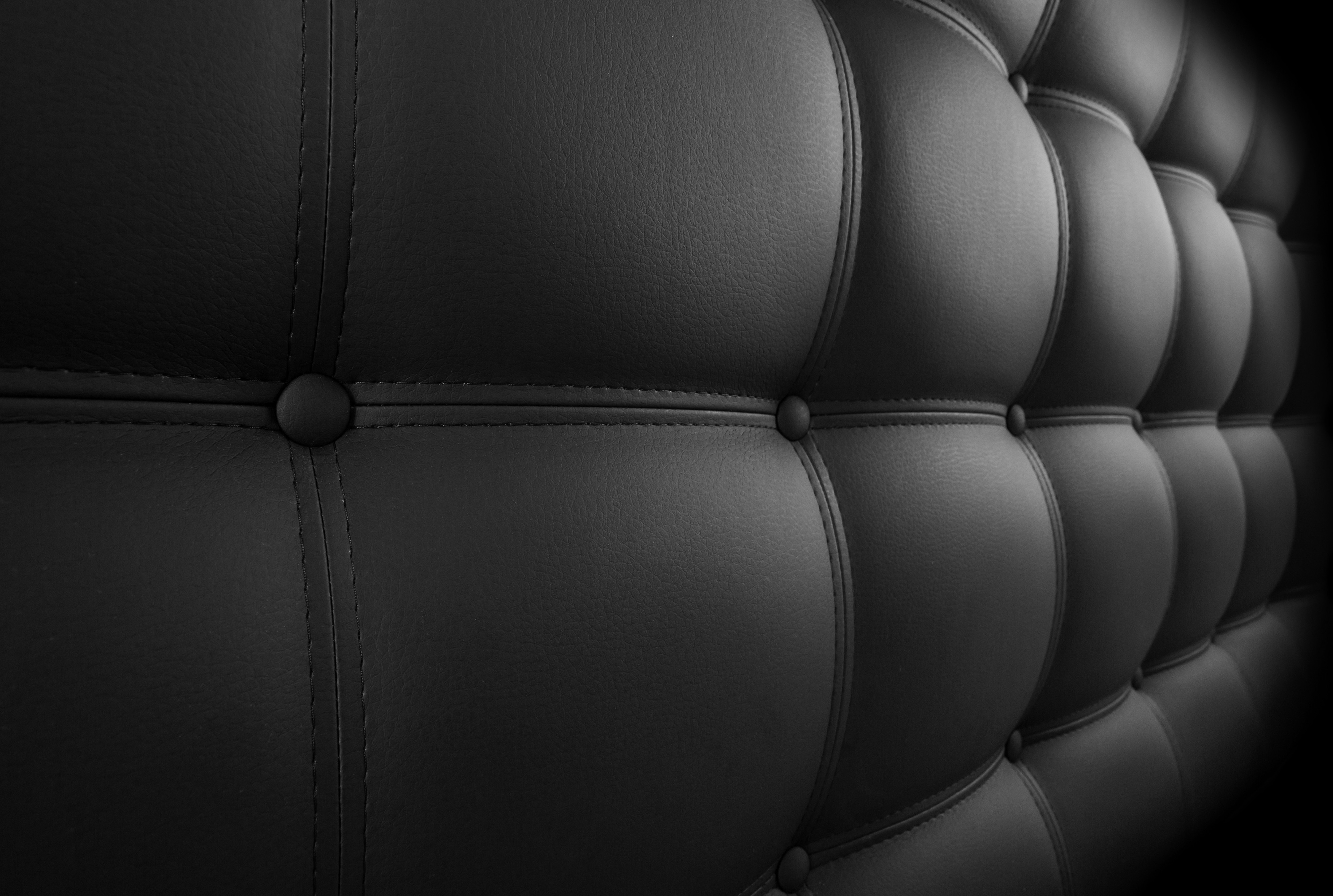 closeup of a black leather padded headboard