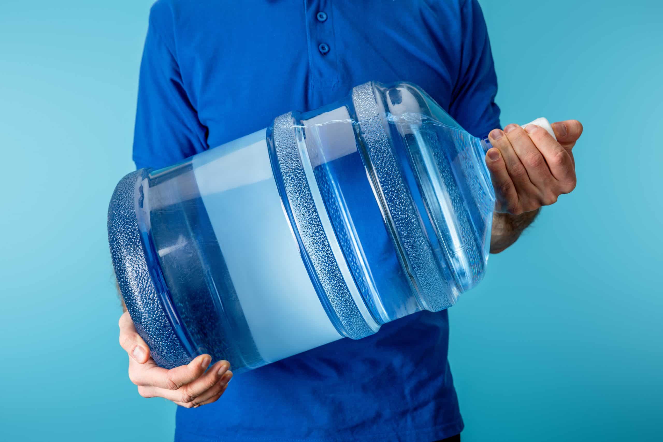 person holding large bottle of water