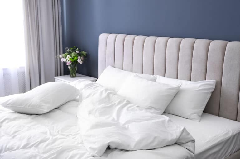 simple modern bed with a white comforter
