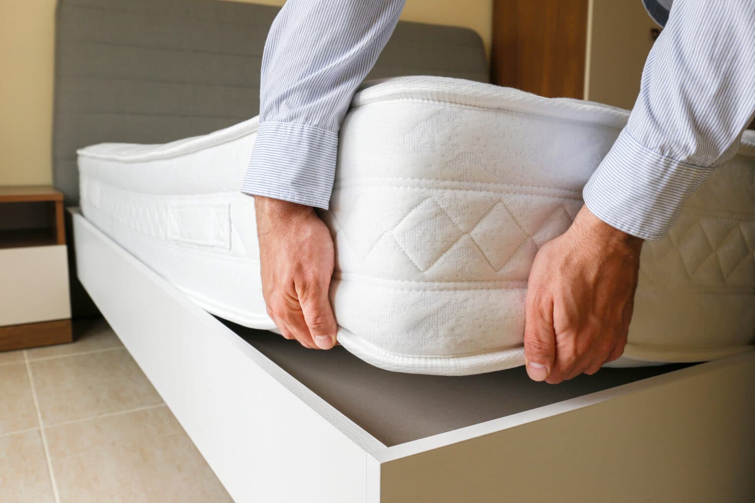 mattress being put into a bed frame