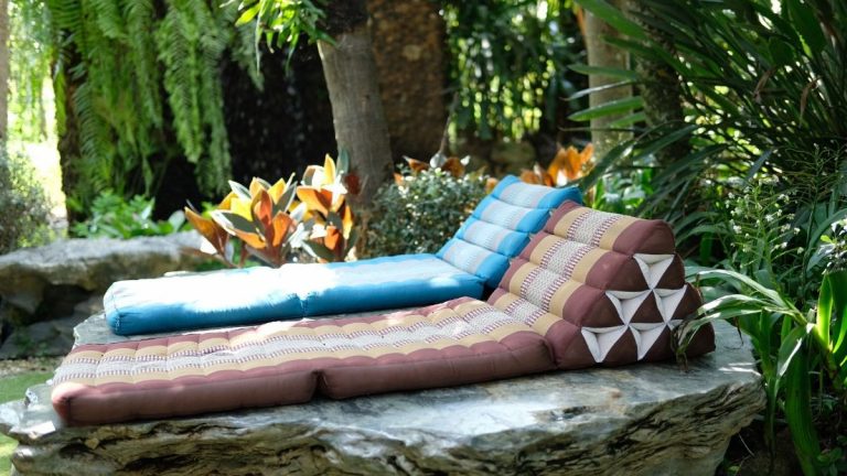 Two folding mattresses with pillows outside in garden