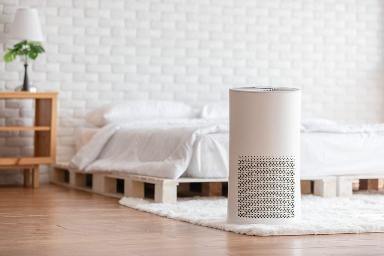 cylindrical air purifier in a bedroom