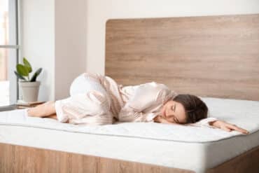 woman laying on a mattress