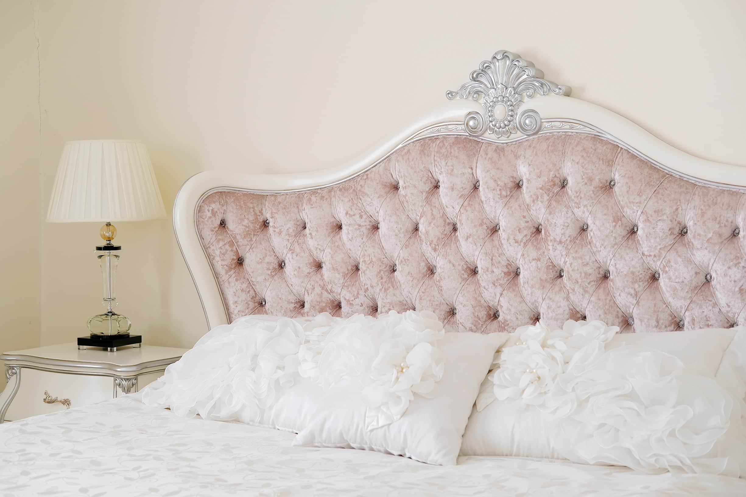 antique white bed set with pink padded headboard