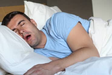 young man sleeping with mouth open, snoring concept