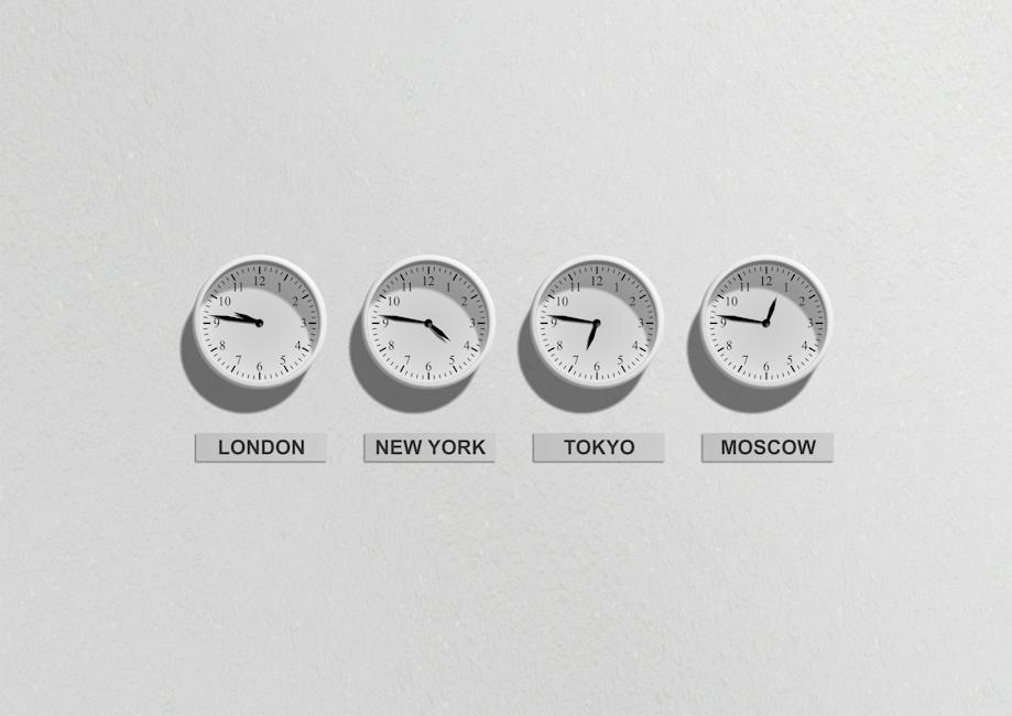 A traveler looking at multiple clocks set to different time zones.