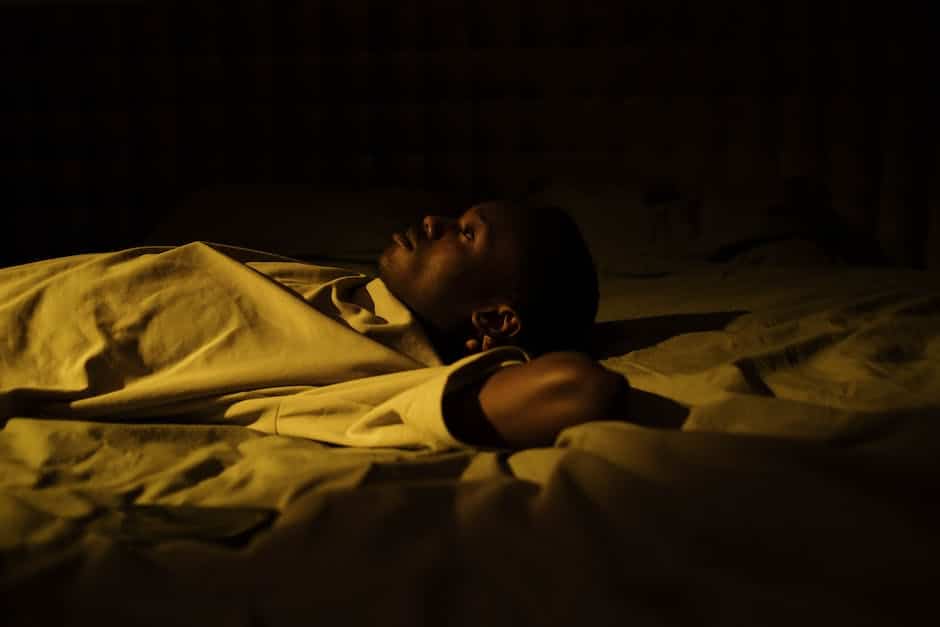 An image depicting someone lying awake in bed at night, struggling to sleep.