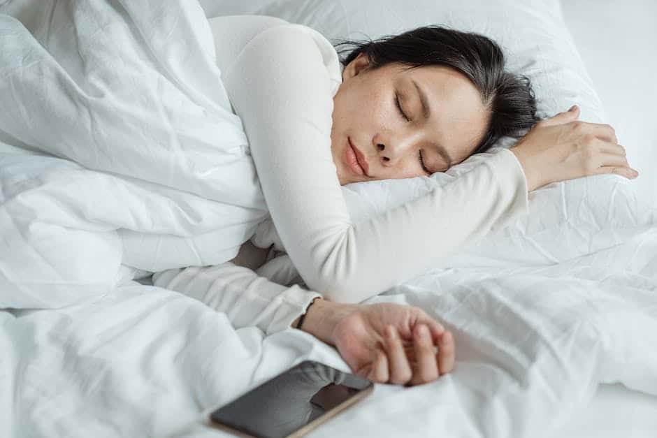 Image of a person peacefully sleeping in bed with a smile on their face